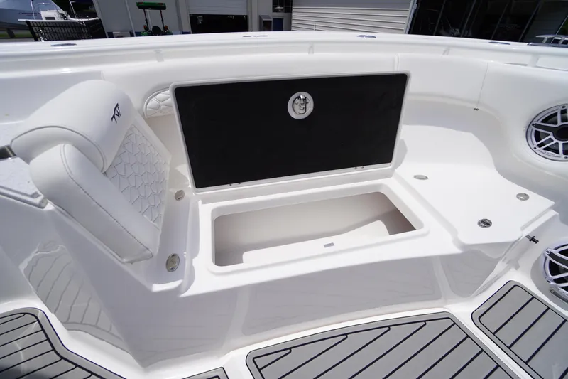 Slide: The Image of 2026 Tidewater 282 CC Adventure boat interior with storage compartment and cushioned seating. - 16