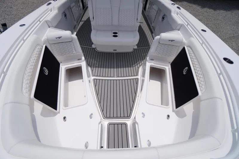 Slide: The Image of 2026 Tidewater 282 CC Adventure boat interior with cushioned seating and storage compartments. - 18