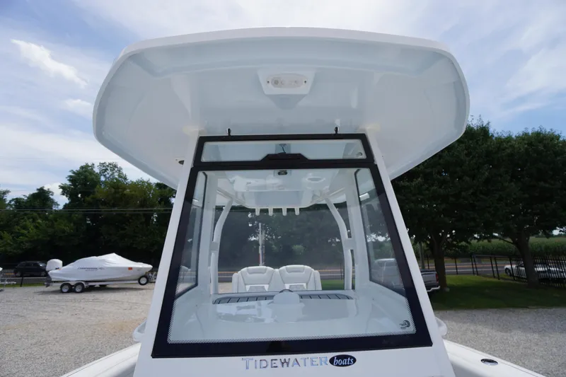 Slide: The Image of 2026 Tidewater 282 CC Adventure boat with T-top and windshield, parked outdoors. - 23