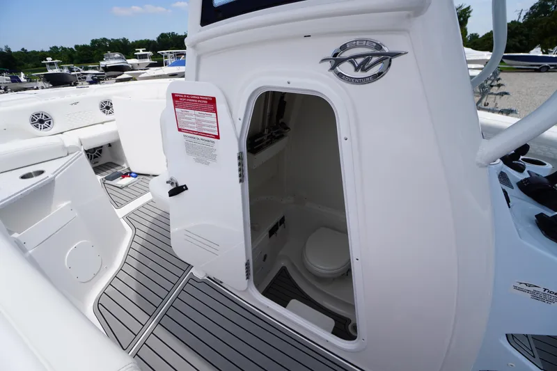 Slide: The Image of 2026 Tidewater 282 CC Adventure boat interior with open cabin door and visible toilet. - 25
