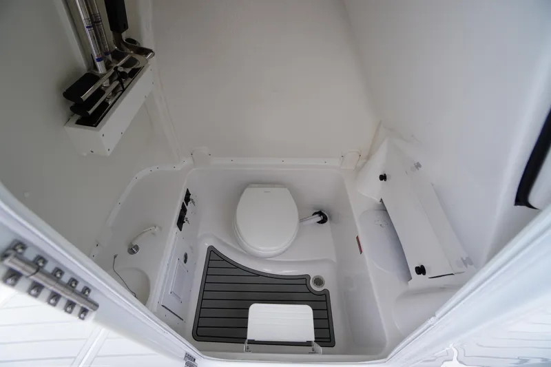 Slide: The Image of 2026 Tidewater 282 CC Adventure boat interior bathroom with toilet and storage. - 26