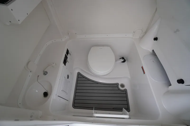 Slide: The Image of 2026 Tidewater 282 CC Adventure boat interior bathroom with toilet and sink. - 27