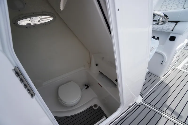 Slide: The Image of 2026 Tidewater 282 CC Adventure boat interior with compact marine toilet. - 29