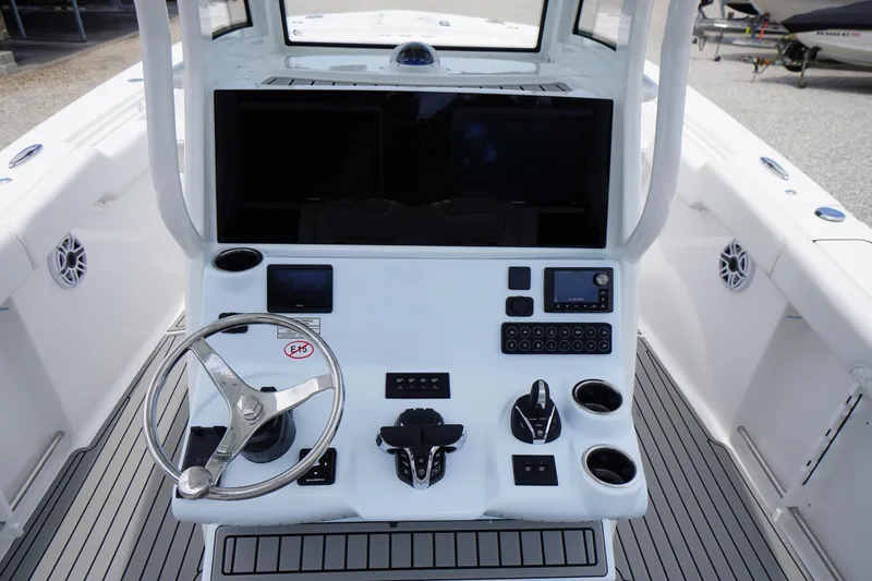 Slide: The Image of 2026 Tidewater 282 CC Adventure boat console with steering wheel and control panel. - 32