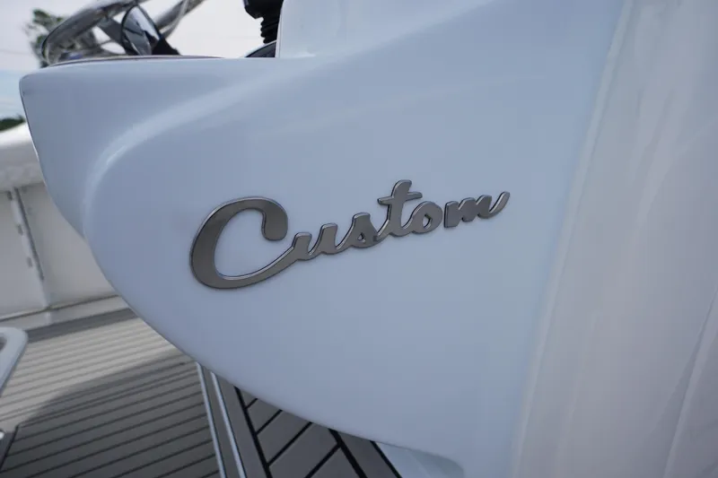 Slide: The Image of 2026 Tidewater 282 CC Adventure boat with "Custom" emblem detail. - 35