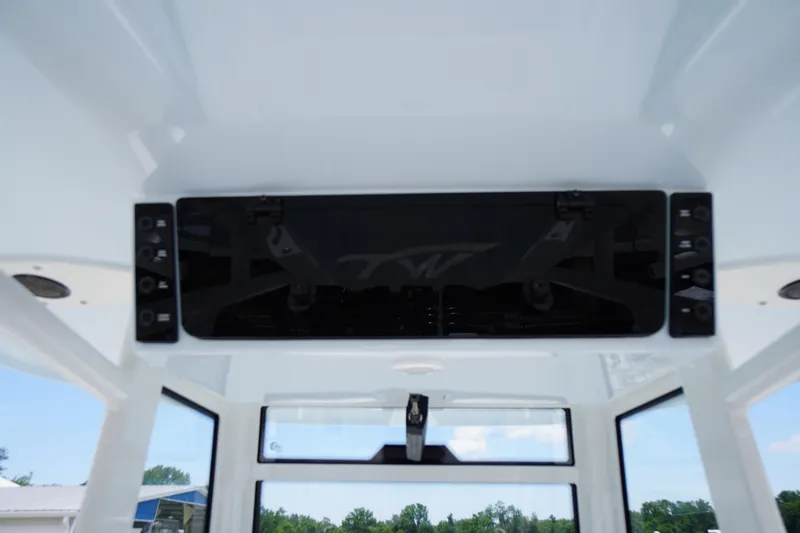Slide: The Image of 2026 Tidewater 282 CC Adventure boat interior with control panel and windows. - 39