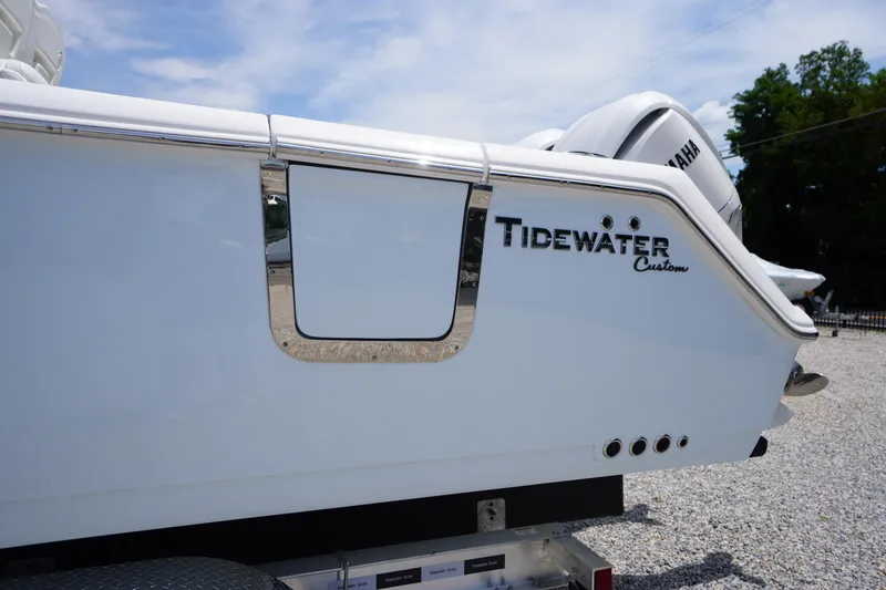Slide: The Image of 2026 Tidewater 282 CC Adventure boat rear view with custom branding. - 4