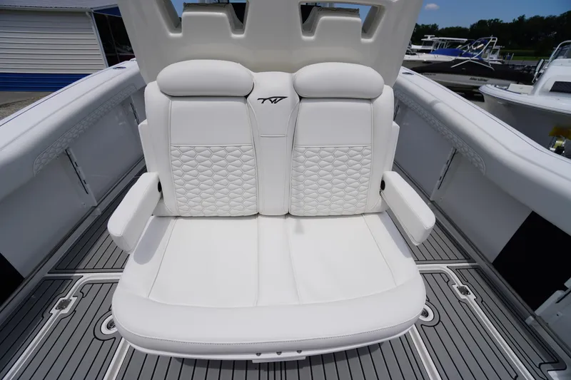 Slide: The Image of Luxurious seating on 2026 Tidewater 282 CC Adventure boat, featuring white quilted upholstery. - 49