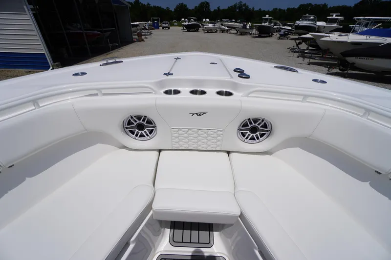 Slide: The Image of 2026 Tidewater 282 CC Adventure boat interior with white seating and speakers. - 6