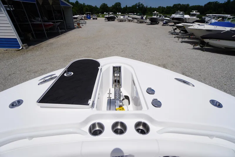 Slide: The Image of 2026 Tidewater 282 CC Adventure boat deck with anchor storage, in a marina setting. - 7
