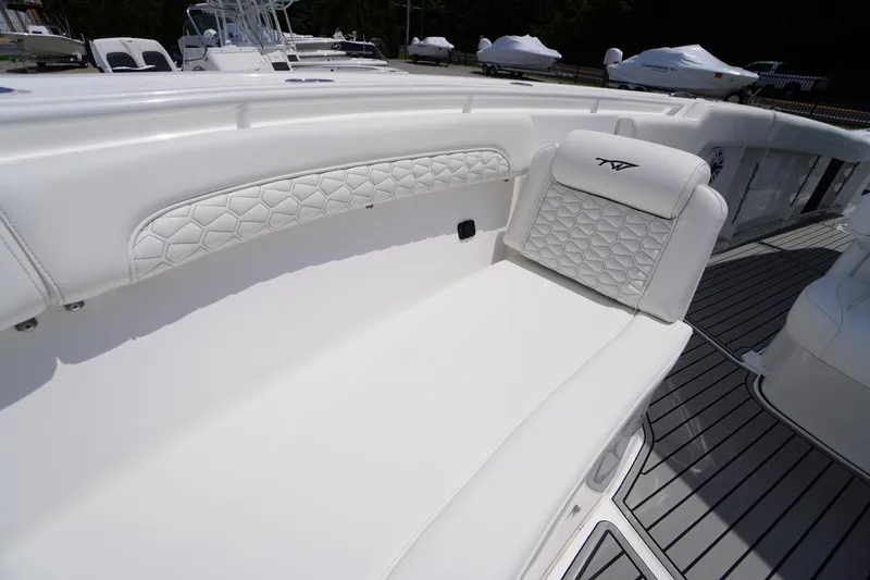Slide: The Image of 2026 Tidewater 282 CC Adventure boat interior with white cushioned seating and sleek design. - 9