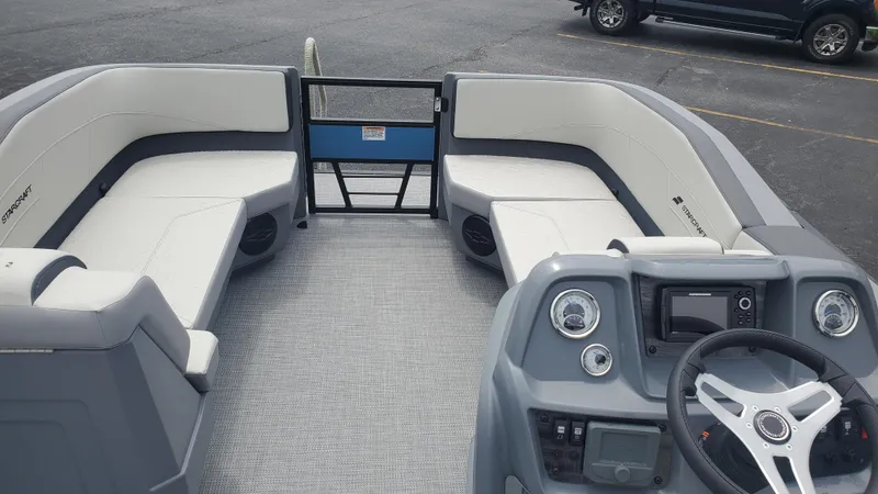 Slide: The Image of 2025 Starcraft GX 22 R DH Sport boat interior with modern dashboard and spacious seating. - 3