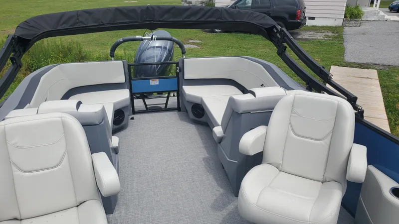 Slide: The Image of 2025 Starcraft GX 22 R DH Sport boat interior with white seating and modern design. - 4