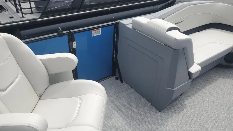 Slide: The Image of 2025 Starcraft GX 22 R DH Sport boat interior with white seating and blue panel. - 5