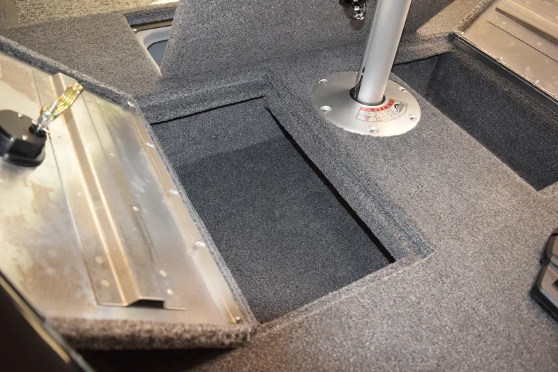 Slide: The Image of Interior of 2025 Tracker Suoer Guide V16 T boat, featuring storage compartments and seat base. - 10