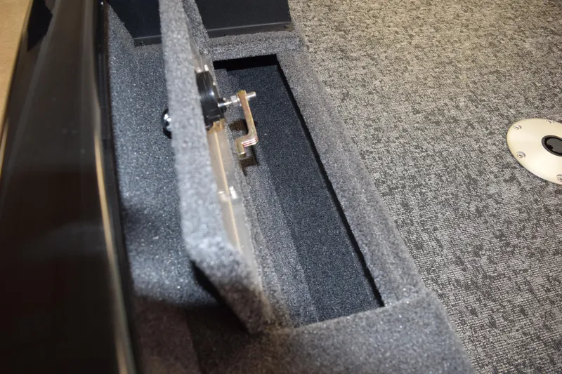 Slide: The Image of Interior compartment of 2025 Tracker Suoer Guide V16 T boat, featuring carpeted storage. - 11