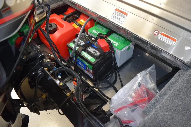 Slide: The Image of 2025 Tracker Suoer Guide V16 T boat engine compartment with batteries and fuel tank. - 17