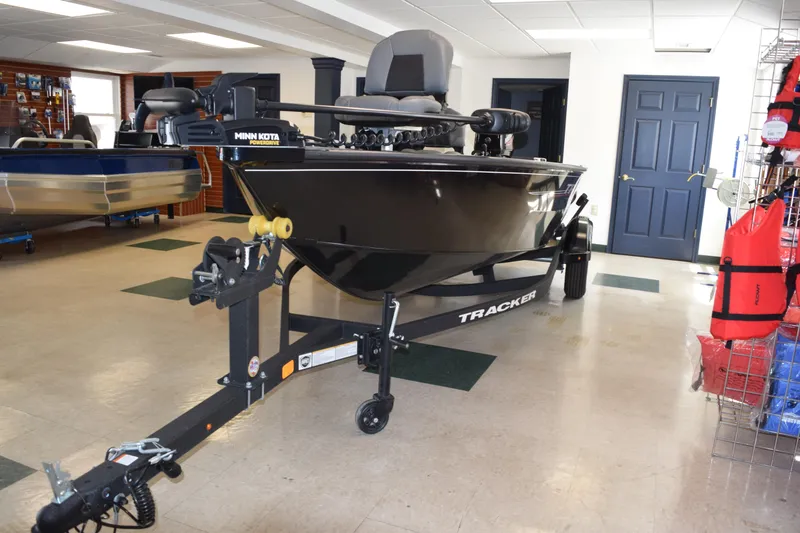 Slide: The Image of 2025 Tracker Super Guide V16 T boat on display in showroom. - 3