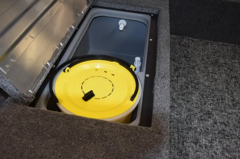 Slide: The Image of Storage compartment in 2025 Tracker Suoer Guide V16 T boat with yellow lid. - 8