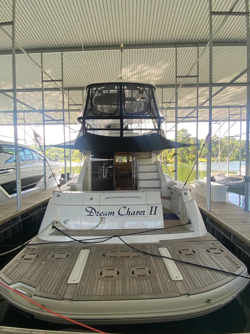 Slide: The Image of 2008 Sea Ray 47DB yacht "Dream Chaser II" docked under a covered marina. - 1