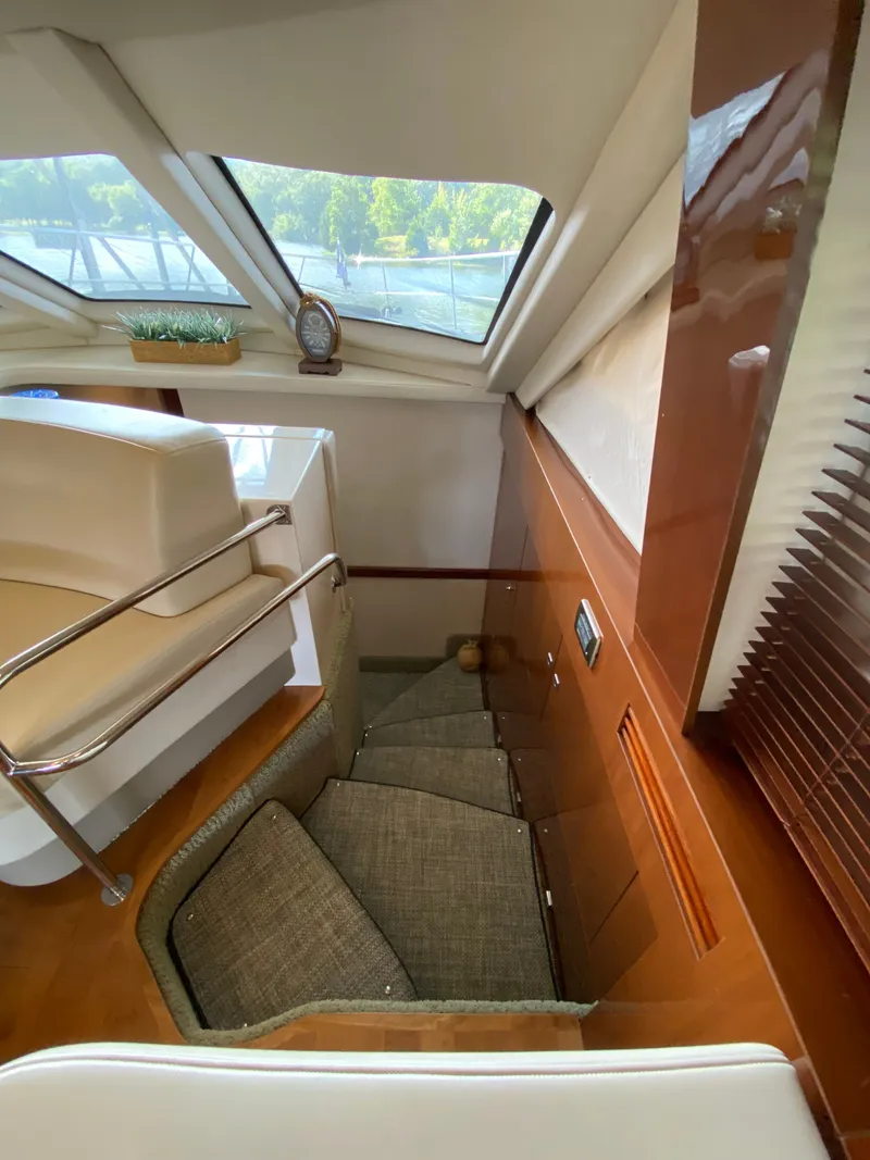 Slide: The Image of Interior of 2008 Sea Ray 47DB yacht, featuring stairs and large windows. - 17