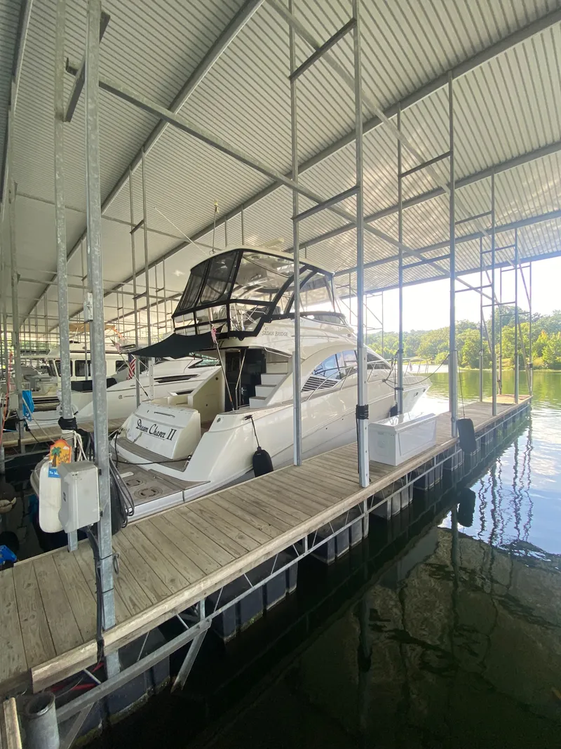 Slide: The Image of 2008 Sea Ray 47DB yacht docked in a covered marina slip. - 2