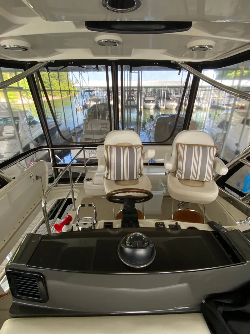 Slide: The Image of Interior view of 2008 Sea Ray 47DB yacht helm with striped cushioned seats. - 29