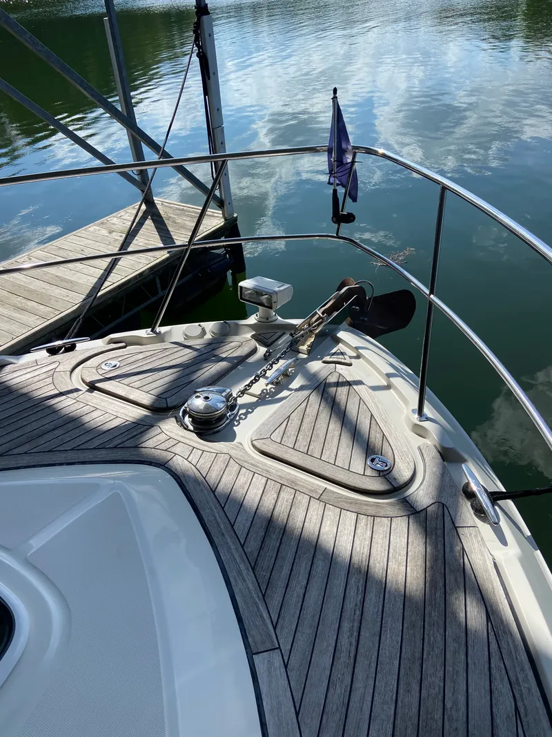 Slide: The Image of Bow of 2008 Sea Ray 47DB yacht with anchor and wooden deck, docked on calm water. - 33