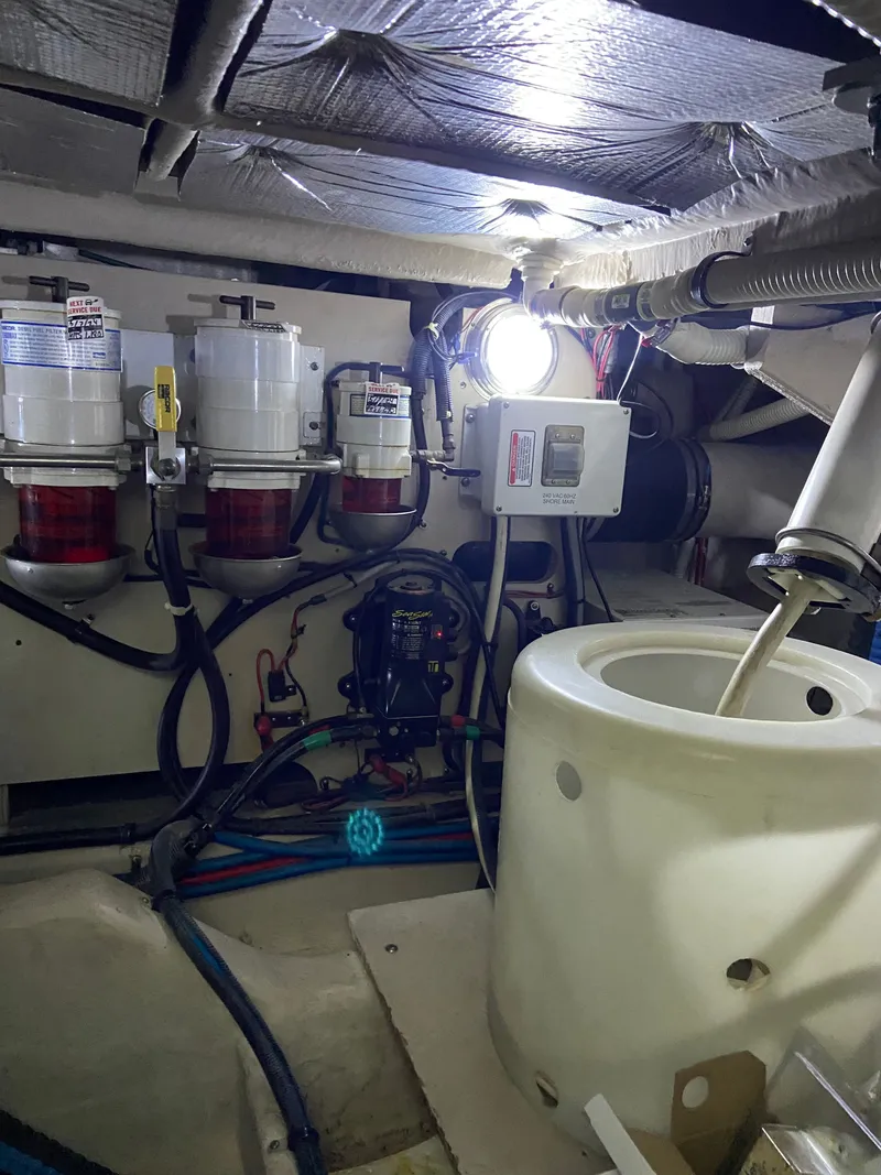 Slide: The Image of Engine room of a 2008 Sea Ray 47DB yacht, showcasing fuel filters and mechanical components. - 39