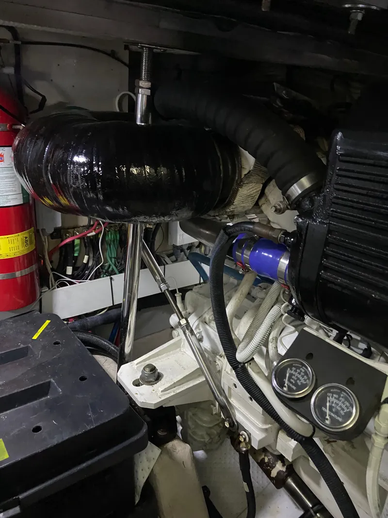 Slide: The Image of Engine room of a 2008 Sea Ray 47DB yacht, featuring mechanical components and fire extinguisher. - 41