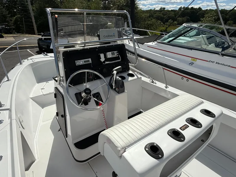 Slide: The Image of 1996 Boston Whaler 19 Outrage boat interior with steering console and seating. - 3