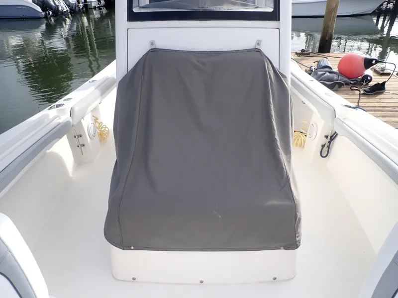 Slide: The Image of 2020 Regulator 23 Center Console boat interior with covered console at marina. - 11