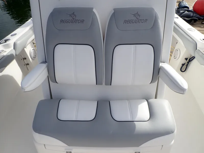 Slide: The Image of 2020 Regulator 23 Center Console boat seating with gray and white cushions. - 12