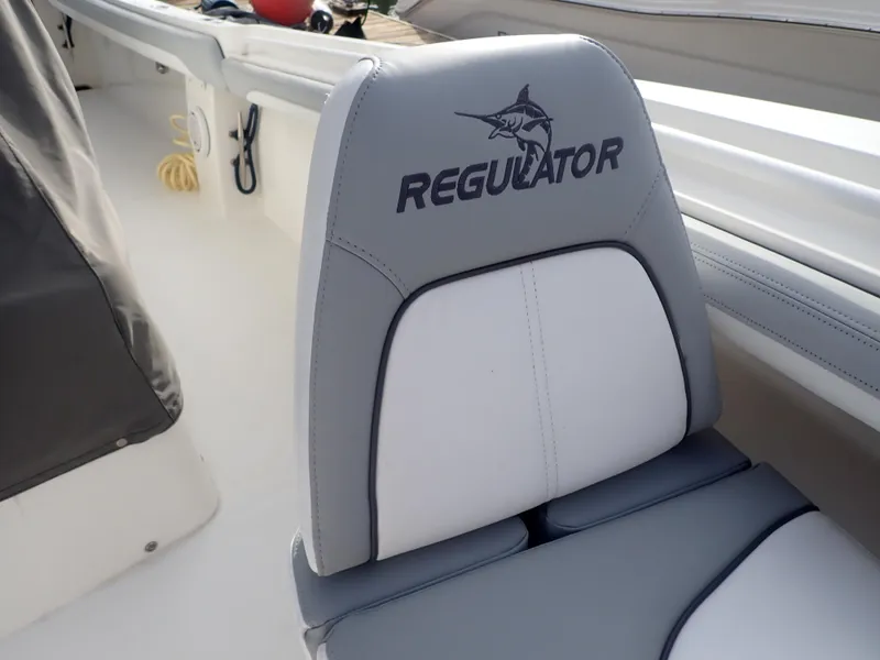 Slide: The Image of 2020 Regulator 23 Center Console boat seat with logo and marlin design. - 14