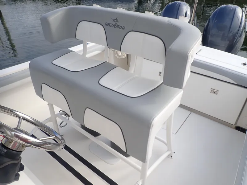 Slide: The Image of 2020 Regulator 23 Center Console boat interior with dual seating and steering wheel. - 15
