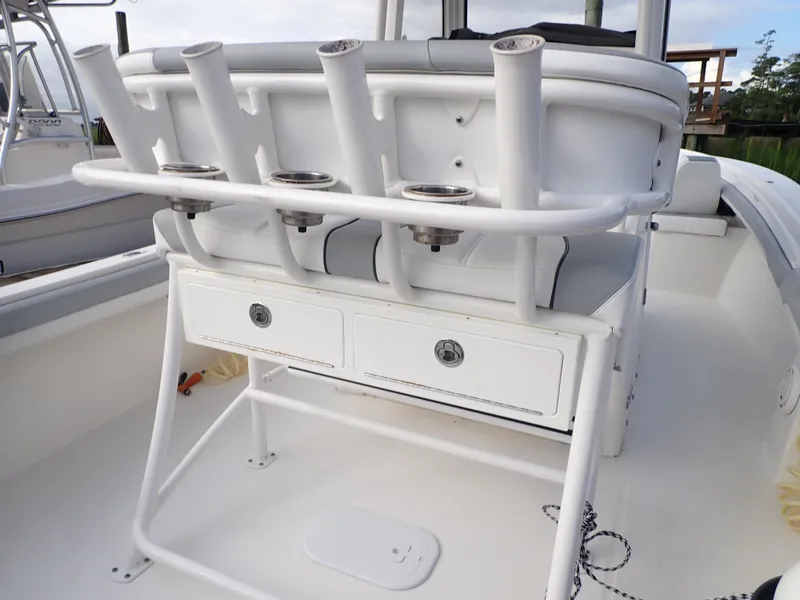 Slide: The Image of 2020 Regulator 23 Center Console boat with rod holders and storage drawers. - 19
