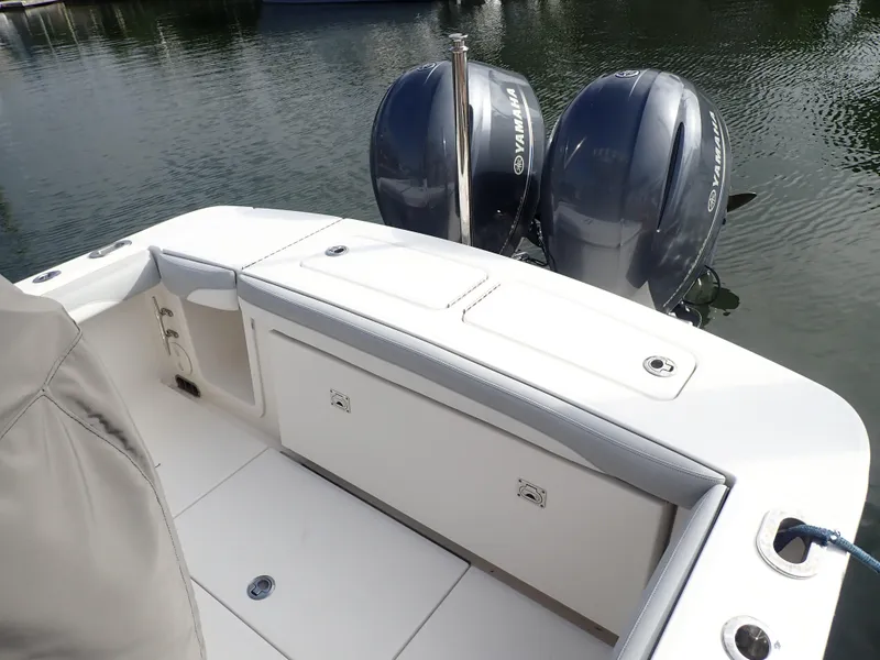 Slide: The Image of 2020 Regulator 23 Center Console boat with twin Yamaha outboard motors on calm water. - 20