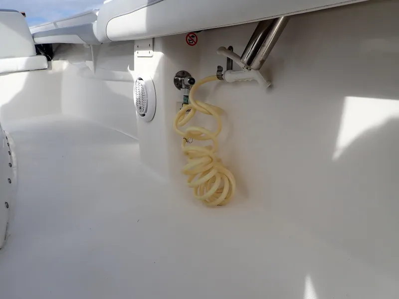 Slide: The Image of 2020 Regulator 23 Center Console boat interior with coiled hose and speaker. - 25