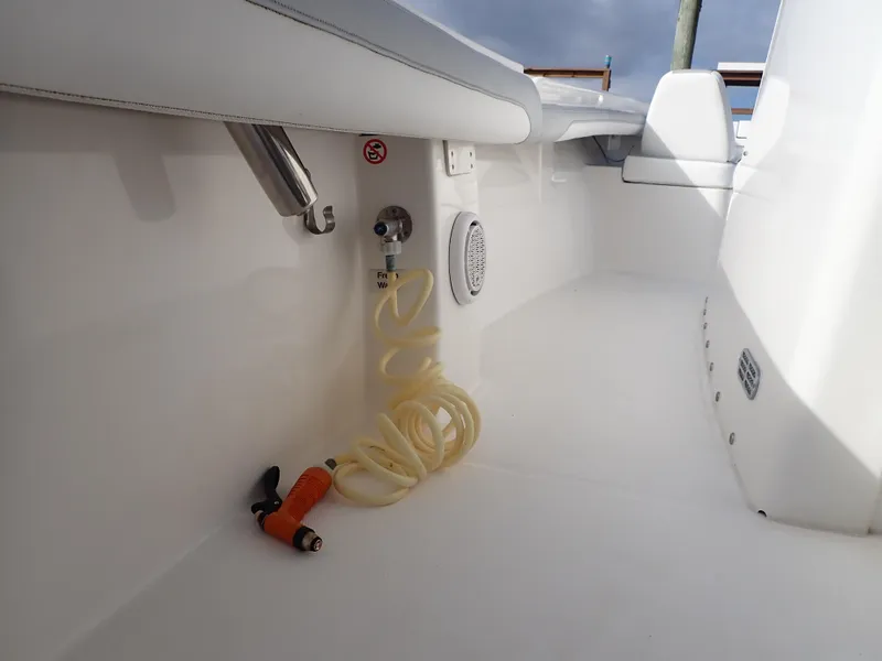 Slide: The Image of 2020 Regulator 23 Center Console boat interior with hose and fittings. - 26