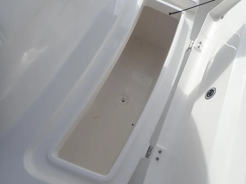 Slide: The Image of 2020 Regulator 23 Center Console storage compartment, open and empty. - 27