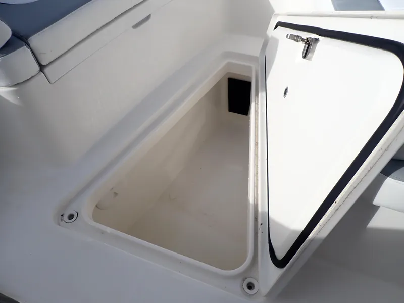 Slide: The Image of Open storage compartment on 2020 Regulator 23 Center Console boat. - 30