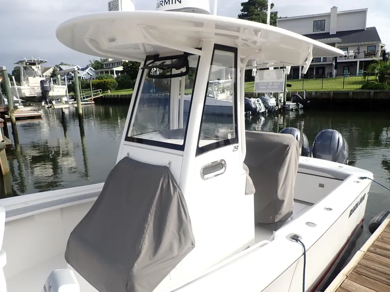 Slide: The Image of 2020 Regulator 23 Center Console boat docked in a marina. - 5