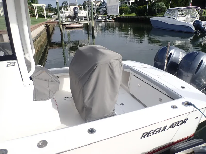 Slide: The Image of 2020 Regulator 23 Center Console boat docked with covered seating area. - 6