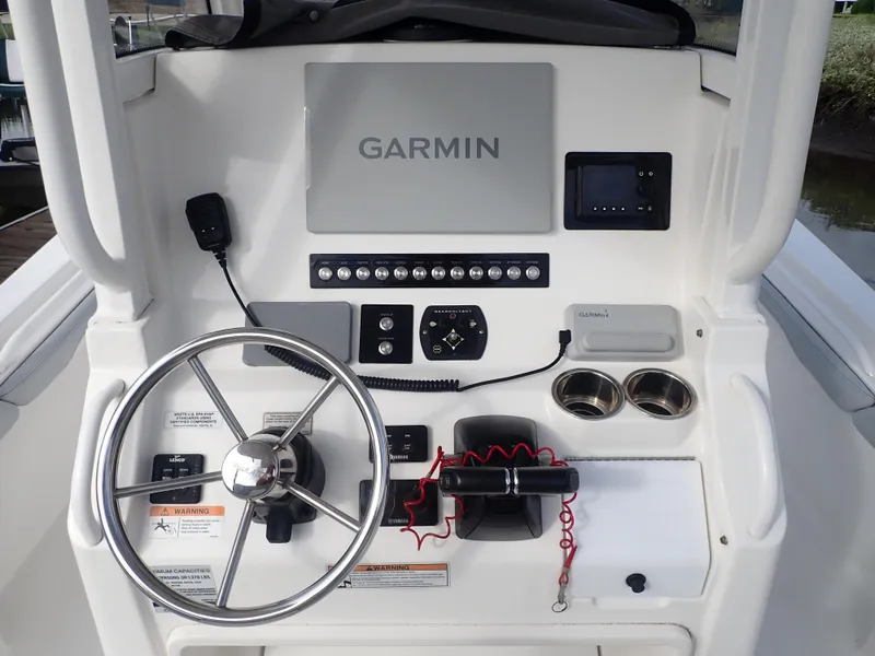 Slide: The Image of 2020 Regulator 23 Center Console helm with Garmin navigation and stainless steel steering wheel. - 9