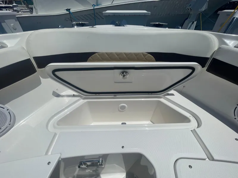 Slide: The Image of 2021 Edgewater 262 CX boat interior with open storage compartment. - 10