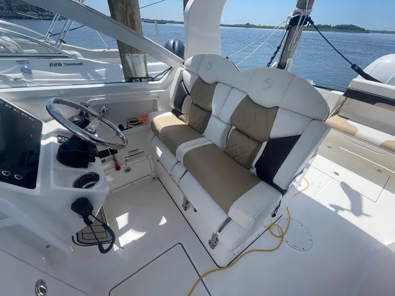 Slide: The Image of Interior of 2021 Edgewater 262 CX boat with plush seating and steering wheel. - 13