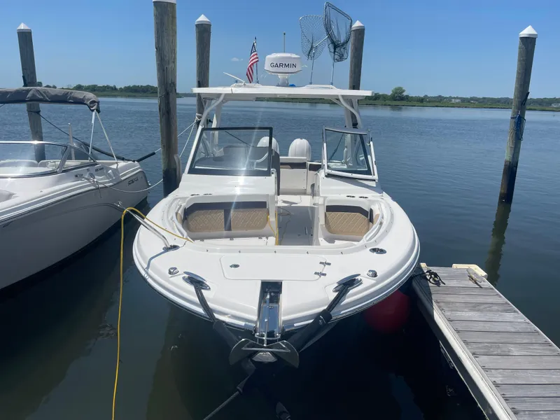 Slide: The Image of 2021 Edgewater 262 CX boat docked on a sunny day. - 2