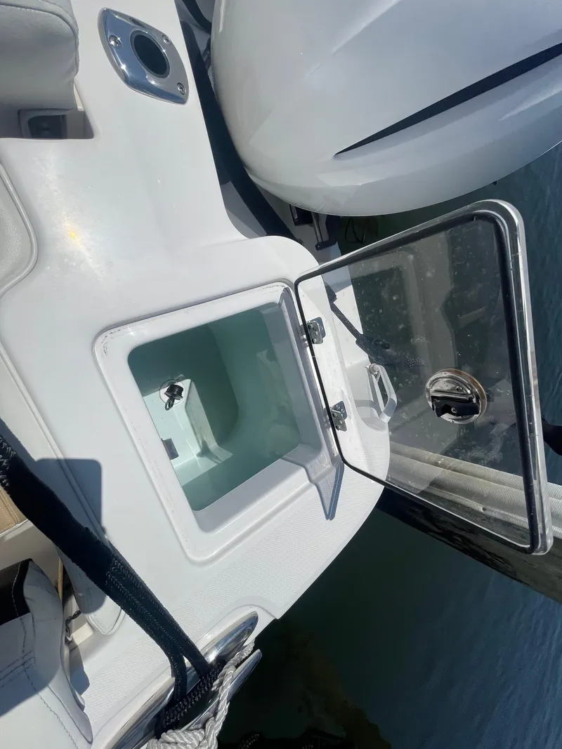 Slide: The Image of Open storage compartment on a 2021 Edgewater 262 CX boat. - 30