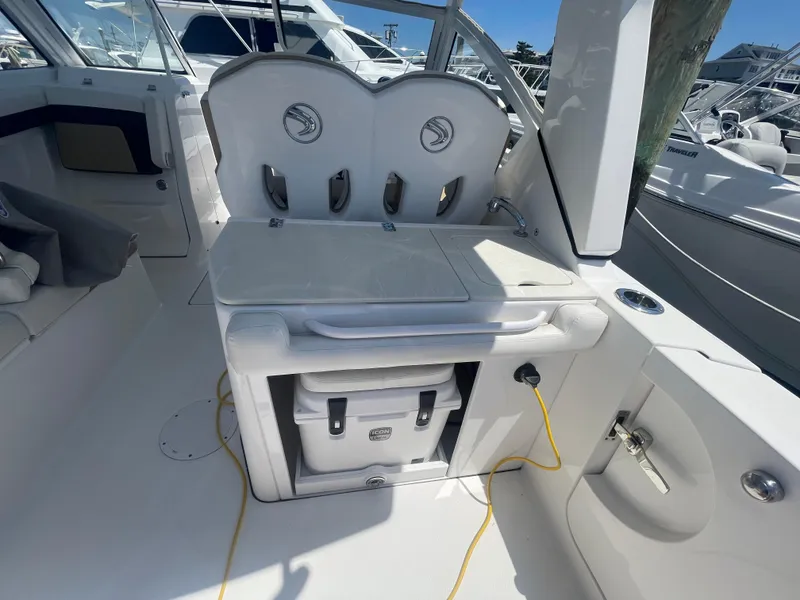 Slide: The Image of 2021 Edgewater 262 CX boat interior with seating and storage area. - 31