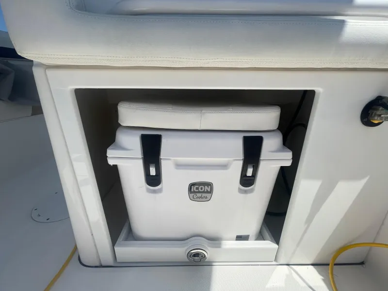Slide: The Image of White Icon cooler stored under seat on 2021 Edgewater 262 CX boat. - 32